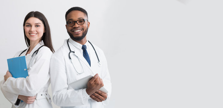 Happy Medic Workers. Portrait Of Two Doctors In White Coats