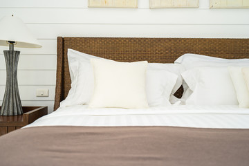 Fototapeta na wymiar Beautiful luxury comfortable pillow on bed with light lamp