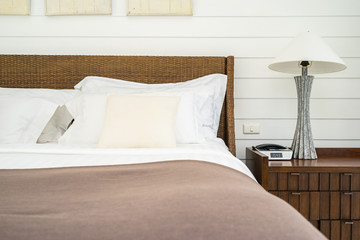 Beautiful luxury comfortable pillow on bed with light lamp