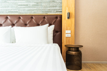 Beautiful luxury comfortable pillow on bed with light lamp