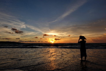 the beauty of Jimbaran beach in Bali Indonesia at dusk with the sun disappearing