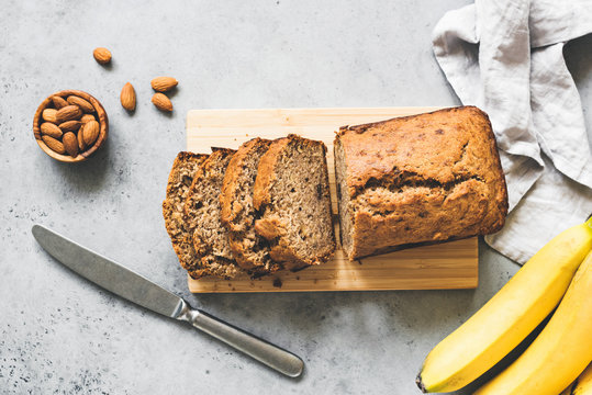 Gluten free paleo banana bread on grey concrete background, table top view