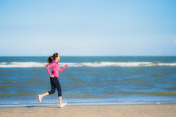 Portrait beautiful young asian woman running or exercise on the tropica nature landscape of beach