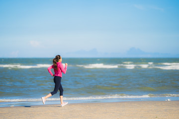 Portrait beautiful young asian woman running or exercise on the tropica nature landscape of beach