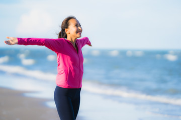 Portrait beautiful young asian woman running or exercise on the tropica nature landscape of beach