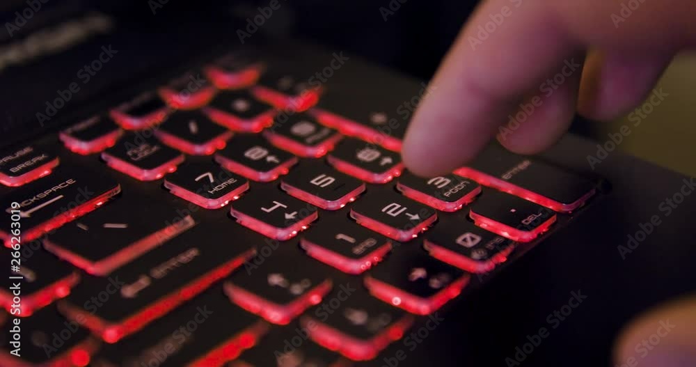 Poster man using numpad on laptop computer