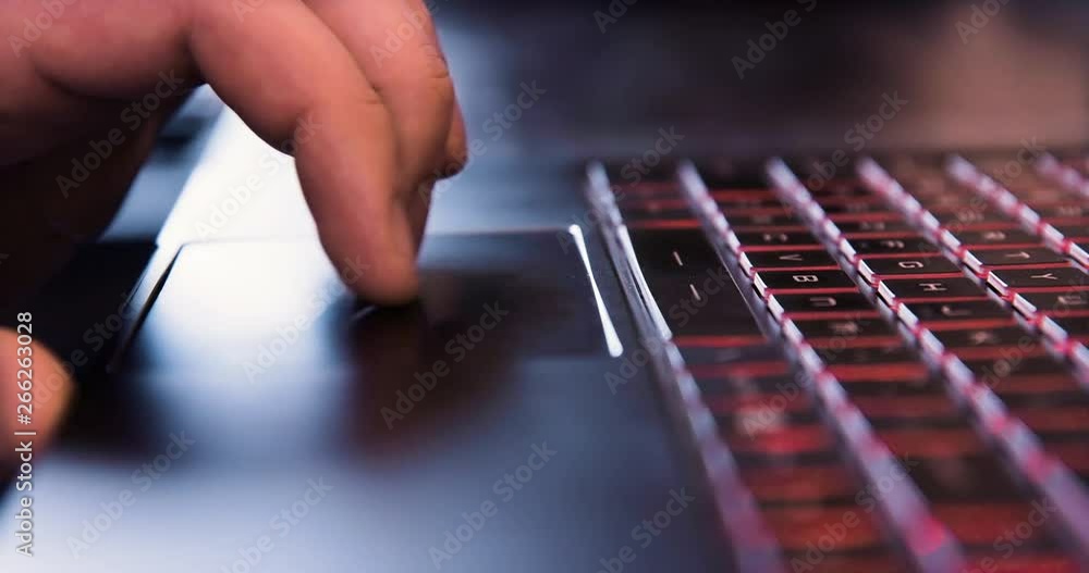 Poster man using touchpad on laptop computer