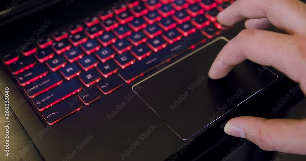 Poster man using touchpad on laptop computer