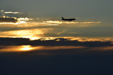 Rich ocean beach sunset behind aircraft on approach to Glenelg South Australia