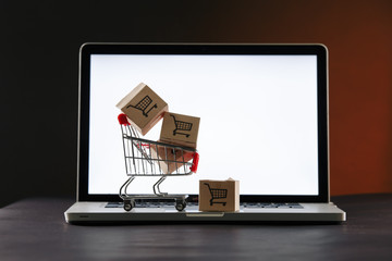 Online shopping. Laptop and boxes on the table