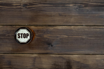 Mug of beer with stop sign on a beer foam. Top view. Space for text