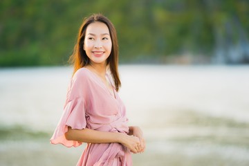 Portrait beautiful young asian woman smile happy walk on the tropical outdoor nature beach sea