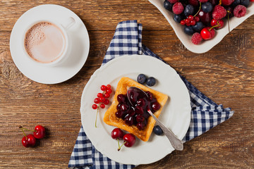 Breakfast. Toasts with cherry or peach jam and fresh fruit.