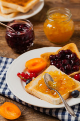 Breakfast. Toasts with cherry or peach jam and fresh fruit.