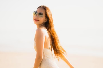 Portrait beautiful young asian woman smile happy walk on the tropical outdoor nature beach sea