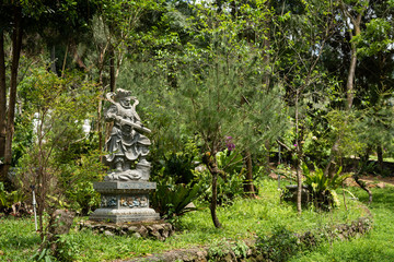 stone ruined Arhat statue in forest