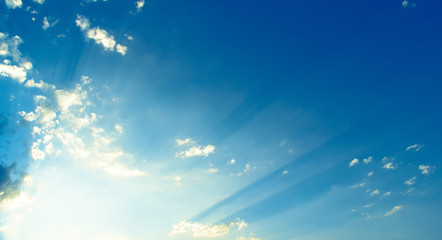 Naklejka na ściany i meble blue sky with clouds and sun's rays, background