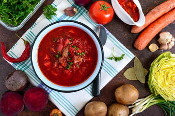 Borsch is a traditional Ukrainian dish in a bowl and products for its preparation. Top view, flat lay.