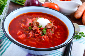 Borsch is a traditional Ukrainian dish in a bowl and products for its preparation.