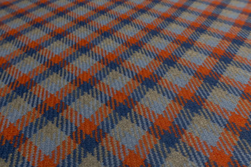 Closeup of colored tartan fabric with textile texture background