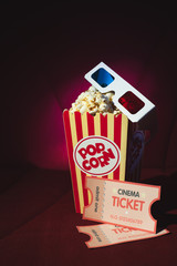 Pop corn and 3d glasses on a cinema armchiair