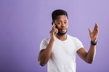 Studio portrait of american man posing with smartphone