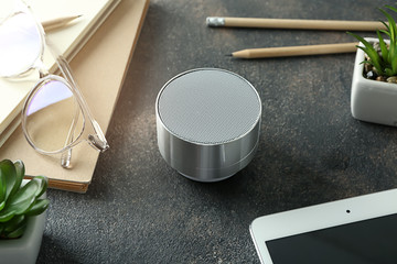 Smart home assistant device on grey table