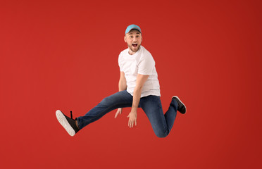 Jumping young man on color background