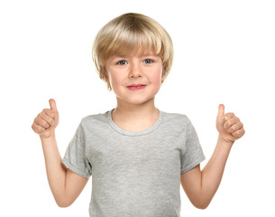 Cute little boy showing thumb-up gesture on white background © Pixel-Shot