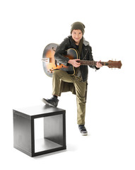 Naklejka premium Cool little boy with guitar on white background