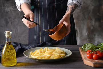 Woman preparing tasty Italian pasta at table