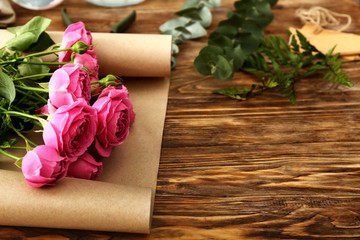 Beautiful roses on wooden table