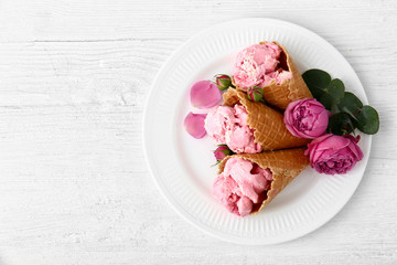 Plate with tasty ice cream on white table