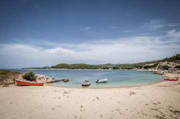 Fototapeta na wymiar Halkidiki, Greece - June 27, 2014: A small cove and boats in a beautiful place of Chalkidiki
