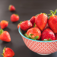 strawberries in the bowl on black background