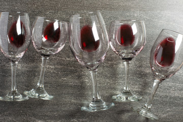 Flat lay background with glasses with red wine on a black background. Concept of wine distillation, winery, wine factory, wine bar, party.