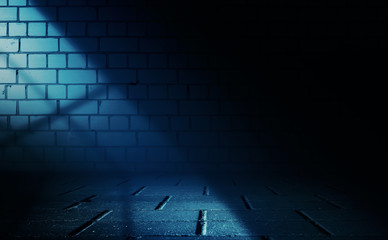 Empty scene background. Incident light from a window on an empty brick wall. Dark abstract...