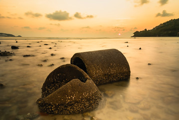 The ruins Cement pipe on the sea in sunset time.Beautiful seascape.Thailand.