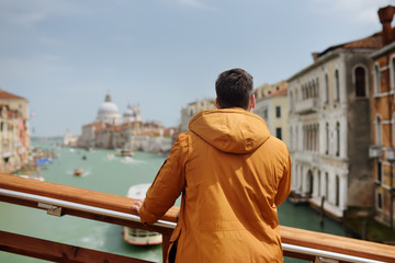 Tourist standing on bridge and admire view of Venice, Italy