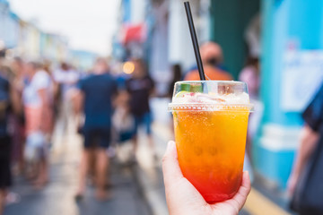 Close Up Of Woman Hands Holding Fruit Cocktail at walking street market.Phuket.Thailand.