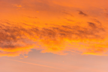 Orange light in morning sky with soft clouds at Thailand.