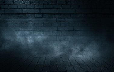 Background of empty dark street. Old brick wall, concrete floor. A spotlight at night illuminates an empty old wall. Smoke, fog