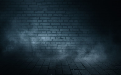 Background of empty dark street. Old brick wall, concrete floor. A spotlight at night illuminates an empty old wall. Smoke, fog