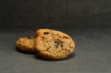 Chocolate chip cookies on black stone background