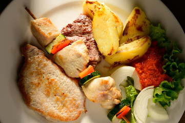 Mixed Grilled meat and vegetables decorated on a plate ready to be served in restaurant