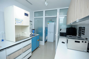 Interior of  the Human Milk Bank laboratory: lab lockers, tables milk heating box, freezers, milk...