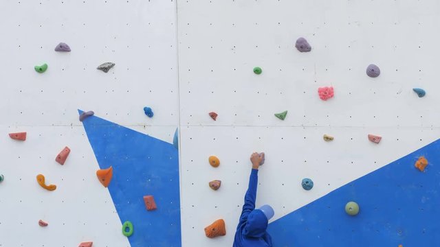 athlete trains on the climbing wall before the competition