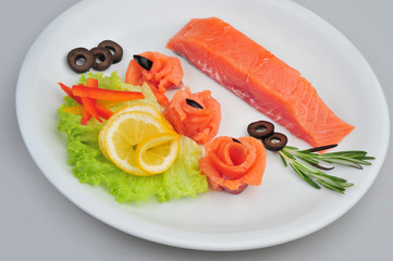 Fresh salmon decorative roses fillets, with lemon, olives on the plate. Isolated on a gray background
