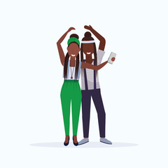 two women taking selfie photo on smartphone camera african american female cartoon characters standing together posing on white background flat full length