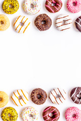 Modern design with bright donuts frame on white background top view mock up